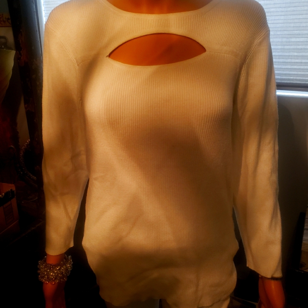 Cream colored top with cut out front.